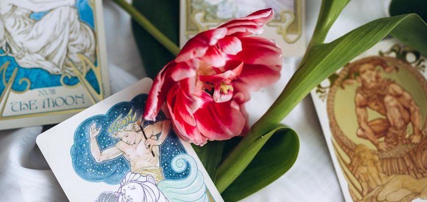 tarot cards lying among red tulips